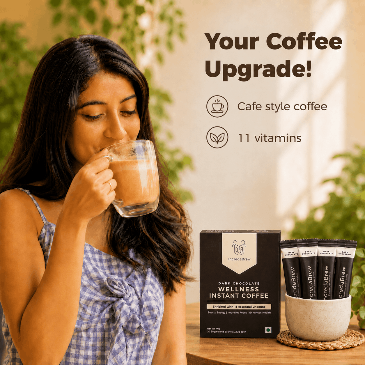 Woman enjoying IncredaBrew Dark Chocolate Flavour Wellness instant coffee beside the box and sachets, highlighting café-style coffee with 11 vitamins.