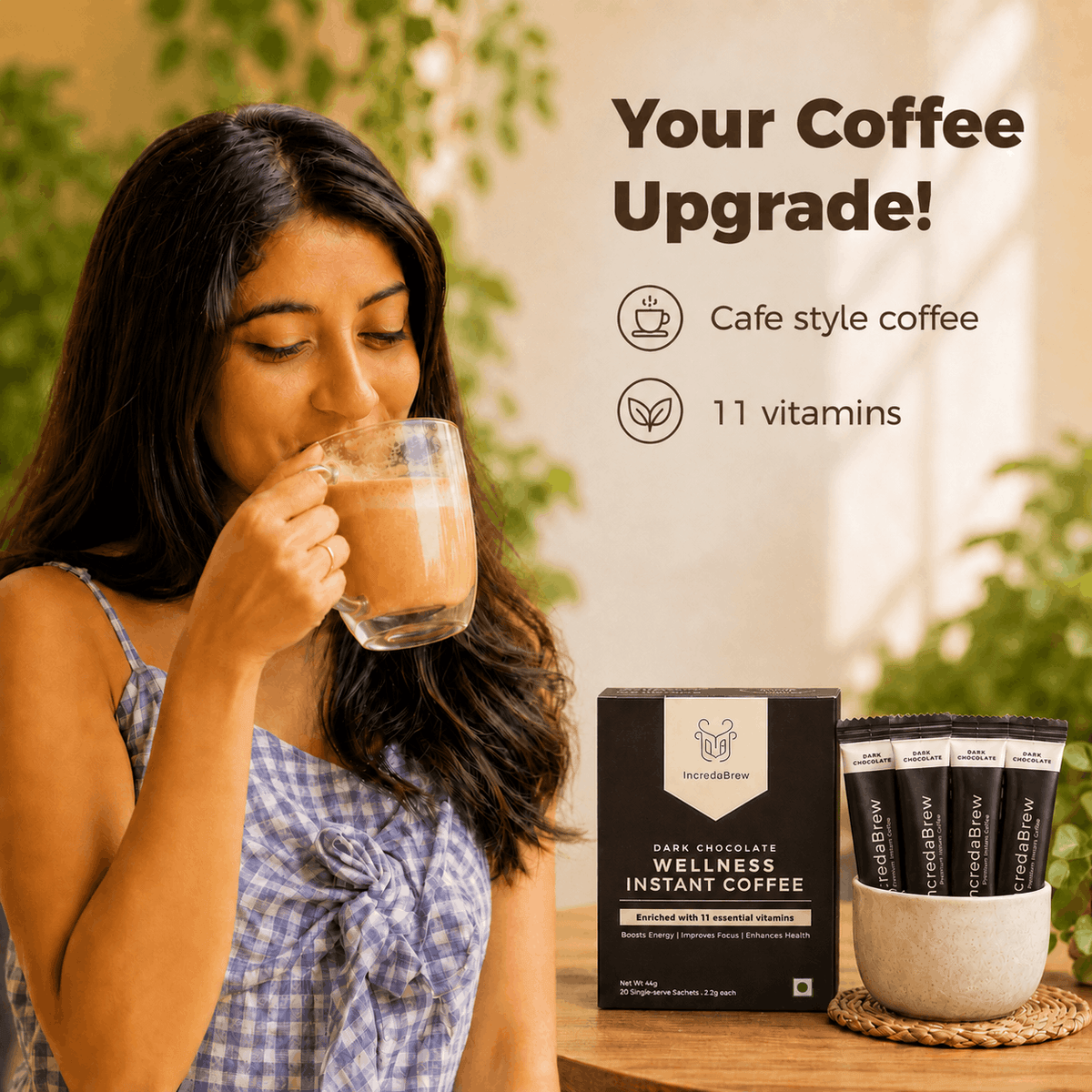 Woman enjoying IncredaBrew Dark Chocolate Flavour Wellness instant coffee beside the box and sachets, highlighting café-style coffee with 11 vitamins.
