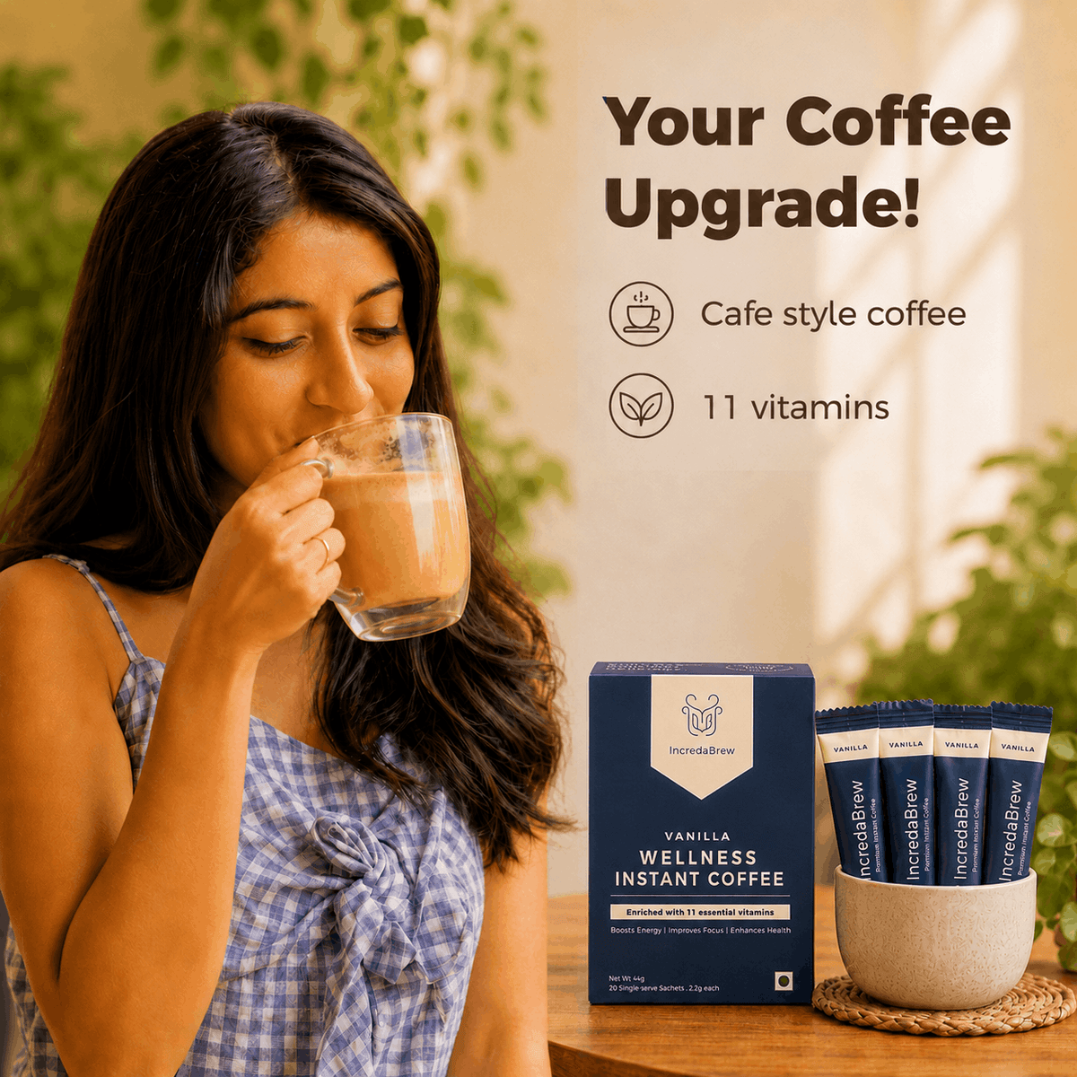 Woman enjoying IncredaBrew Vanilla Flavour Wellness instant coffee beside the box and sachets, highlighting café-style coffee with 11 vitamins.